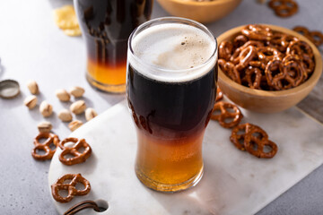 Black and tan cocktail with pale ale and dark stout beer, traditional stout cocktail