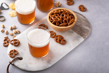 Lager beer or ale on the table with salty snacks