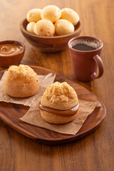 Brazilian snack. Pão de Queijo filled with dulce de leche. Black coffee. Breakfast.