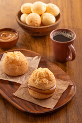 Brazilian snack. Pão de Queijo filled with dulce de leche. Black coffee. Breakfast.