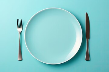 Blue monochrome plate and cutlery. Minimalistic concept for meals.