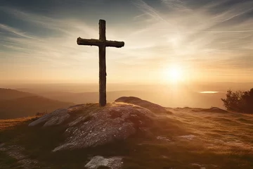 Fotobehang Sunlit hill with Christian cross symbolizing the rising of Jesus © The Big L