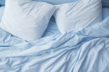 Messy bed in a blue bedroom with white bedding
