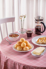 Boho Breakfast table. Typical Brazilian breakfast. P&atilde;o de Queijo. Black Coffee. Butter toast. Granola.