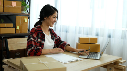 Online seller Close up hands Young asian woman typing laptop keyboard checking online order, check...