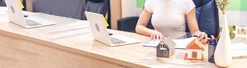 Banner Businesswoman selling house real estate agent at office desk. Women working home insurance...