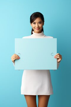 Young Asian woman holding a blank sign