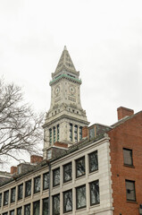 Street view photography of the city of Boston in the area of Faneuil Hall and Quincy Market. These historic and old brick buildings with towers are iconic for New England and Massachusetts.