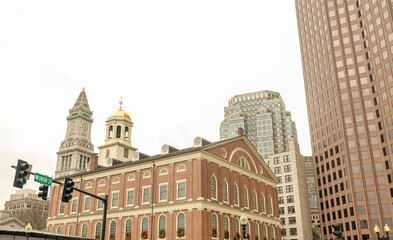 Street view photography of the city of Boston in the area of Faneuil Hall and Quincy Market. These historic and old brick buildings with towers are iconic for New England and Massachusetts.