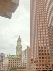 Naklejka premium A sightline of the iconic clock tower in Boston Massachusetts and different buildings surrounding the downtown area. 