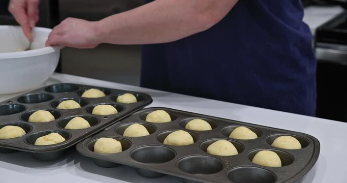 Brazilian cheese chipa buns being prepared for baking on baking tray