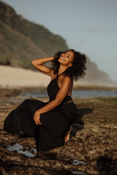Portrait of happy young black woman relaxing on the beach, enjoy her summer vaction