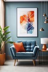 Blue armchair with orange pillow in front of blue wall with abstract painting