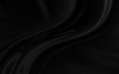 Black gray satin dark fabric texture luxurious shiny that is abstract silk cloth background with patterns soft waves blur beautiful.