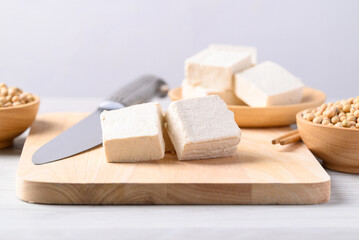 Fresh tofu on cutting wooden board, Vegan food ingredient in Asian cuisine, Plant based diet