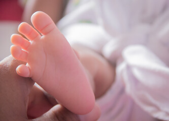 newborn feet in hand