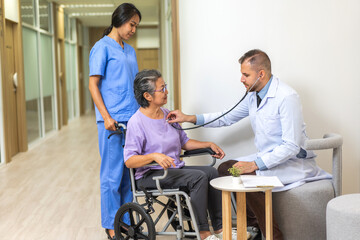 Obraz premium Man doctor with stethoscope service help support discussing and consulting care talk to sick senior asian woman patient in hospital,caregiver,elderly,recovery,illness insurance.healthcare and medicine