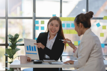 Two happy asian businesswoman talking and consulting working together in the office.