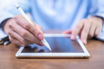 Closeup hand pen writing black screen background digital tablet technology work office business person, online internet job businessman using planning stylus electronic device note document