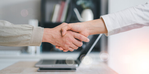 Hands of business colleagues shaking hands at work place. Business partnership meeting concept....