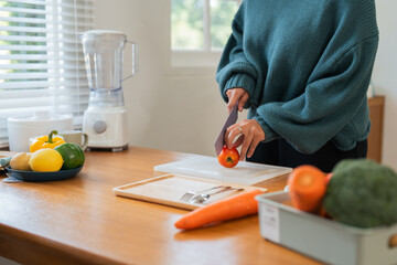 Fat woman cook in kitchen and chopping fresh vegetable on chopping board. health care concept Eat healthy food to lose weight - obrazy, fototapety, plakaty