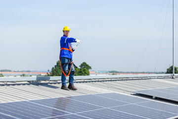 Technicians are installing and inspecting standards of solar panels on roof of an industrial...