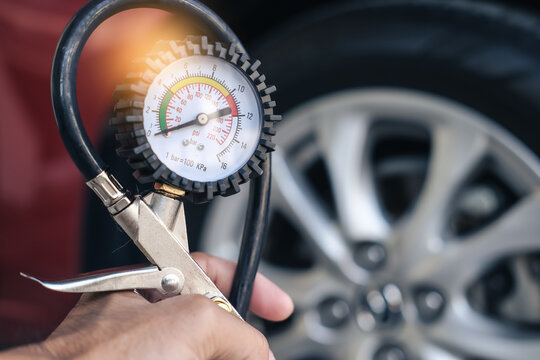 Service Maintenance car inspection Measure quantity Inflated Rubber tires car closeup hand holding machine Inflated pressure gauge car tyre pressure measurement automotive automobile Check car travel