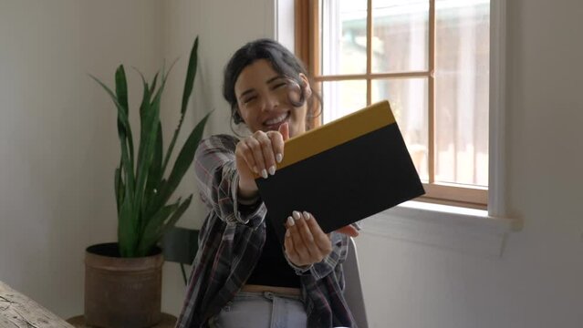 Joyful Puerto Rican girl looking at camera happy smiling gratitude with new reading book