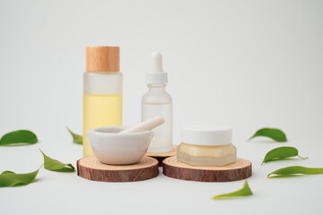 Skin care with pastel and mortar on wooden podium with natural leaf on the way background.