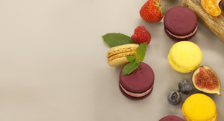 Table filled with array of macaroons and fruits