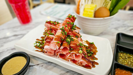 Close-up raw fresh pork slide in white plate on table, Fresh raw pork slides on plate served for...