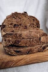 Homemade pate and bread with cranberries and raisins on a wooden board