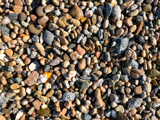 background of pile of small sea stones of various colors