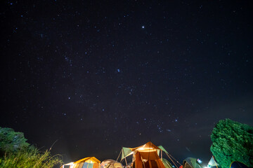 travel and people activity concept with star in the night with camping tent