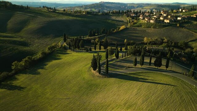 Drown descends orbitting around winding road down picturesque mountain, Val d'Orcia Tuscany