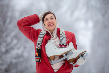 Beautiful middle aged woman or elderly woman with skates enjoys winter.Winter has come