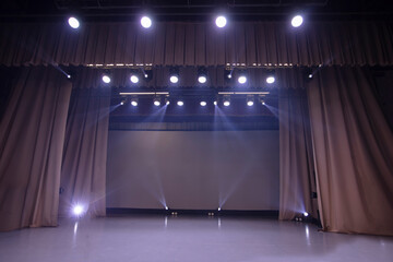 The stage is illuminated by white spotlights.