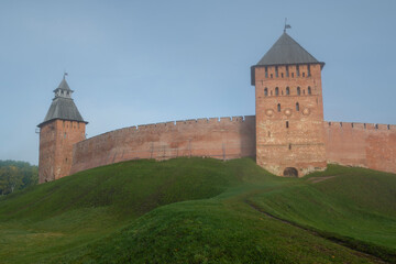Fototapeta na wymiar Two ancient towers of the Kremlin of Veliky Novgorod in the morning October haze. Russia