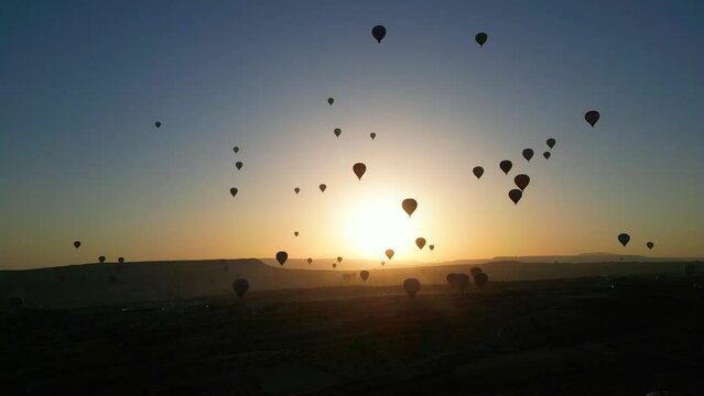 Aerial view of back light amazing hot air balloons in Cappadocia - Turkey.