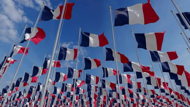 Flags of France blowing in the wind. Flags of France waving over a blue sky. France Flags on pole for Independence day. The symbol of the state on wavy fabric.