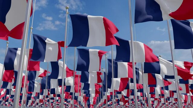 Flags of France blowing in the wind. Flags of France waving over a blue sky. France Flags on pole for Independence day. The symbol of the state on wavy fabric.
