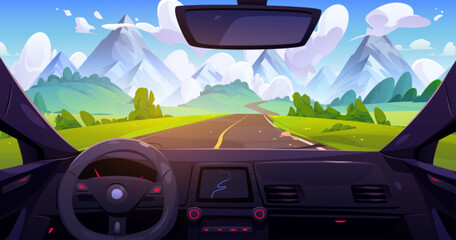 View from car through windshield on road going across meadow with green grass to high rocky mountains under blue sky with clouds. Summer landscape through automobile window with navigation panel.