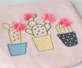 Pink handmade zipper pouch with cute cacti in pots