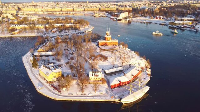  view of Stockholm, Sweden in winter, with snow. Kastell fort, kastellholmen, skeppsholmen and the old town. Morning sunlight, boat passing by. Grona lund in the distance. with spreading rights.