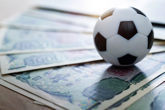 Soccer ball on stack of yen