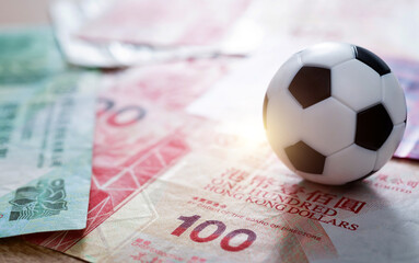 Soccer ball on stack of Hongkong dollars