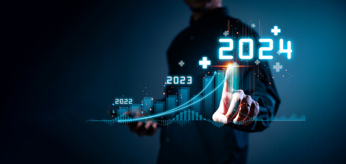 Businessman hand holding the increase arrow graph corporate future growth year 2023 to 2024. New...