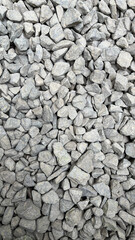 Rough texture of wall made of small gray cement pebbles. Small uneven gravel texture