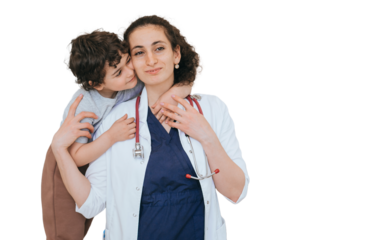 Grateful little boy embracing doctor at medical office. Cheerful female doctor with stethoscope on neck smiling  against transparent background. Children healthcare, medicine.