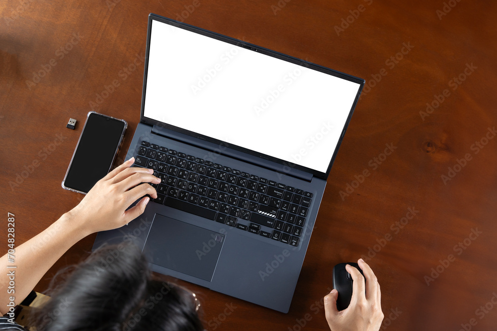 Poster top view of hand use laptop computer with blank screens on white office desk table.cropped shot of b
